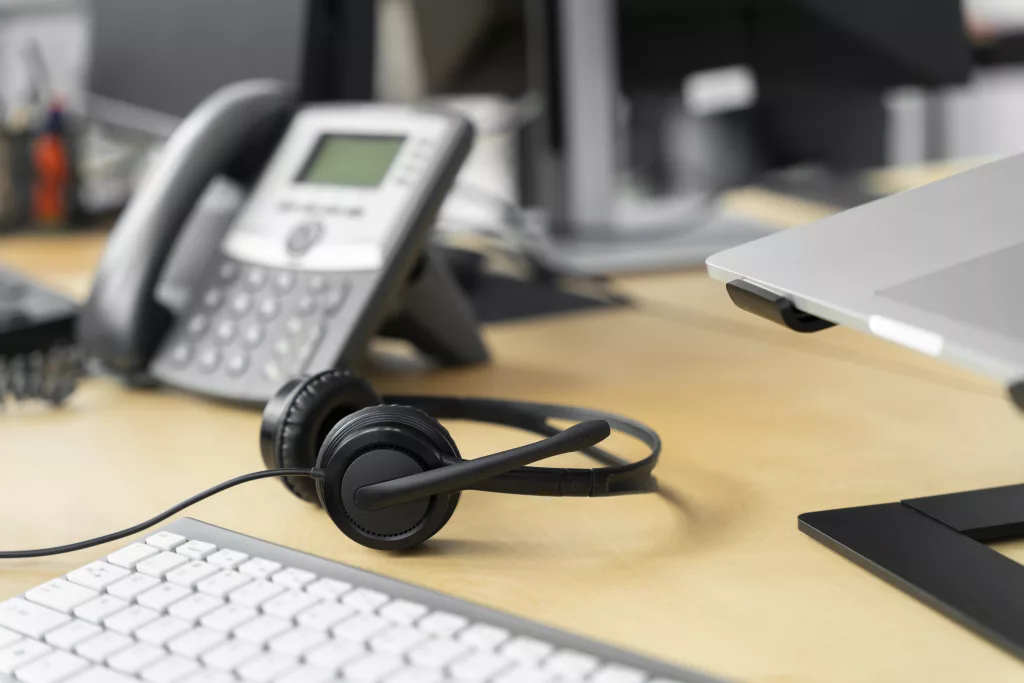 Headset and phone on office desk